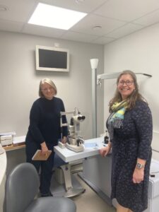 Louise Nicklin and another lady stood in a optometrist's testing room